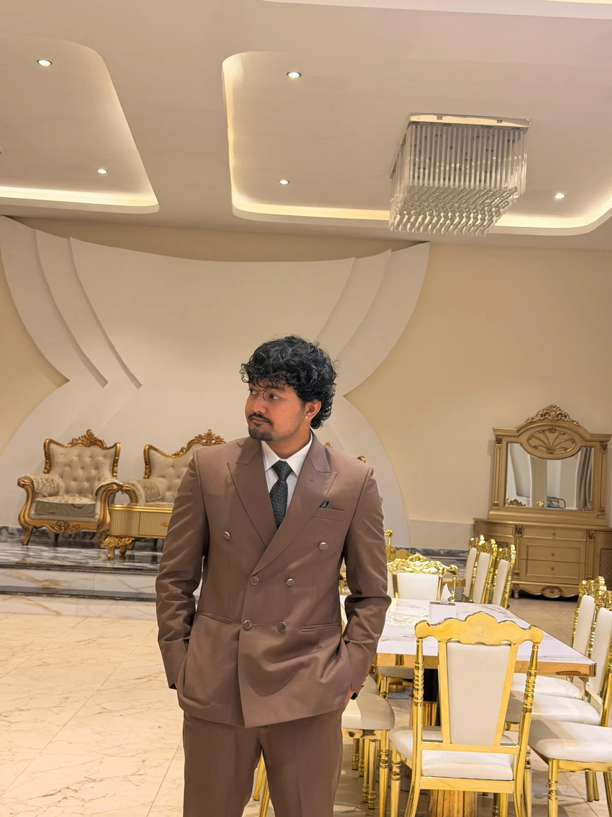 Surya in a brown suit